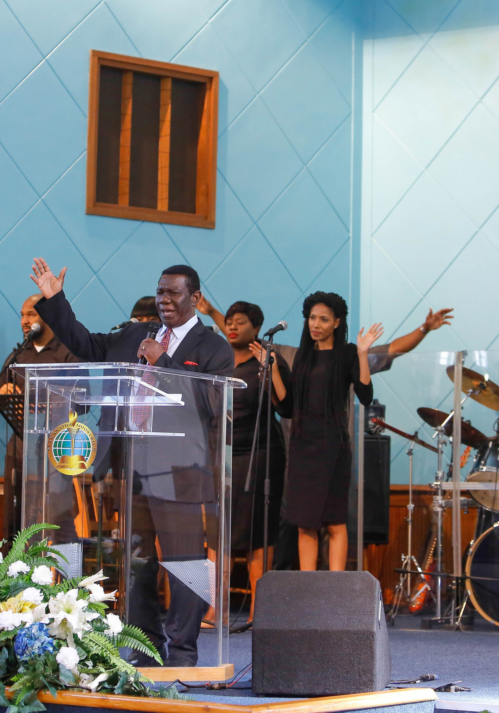 A preacher and singers leading a Maranatha Ministries service